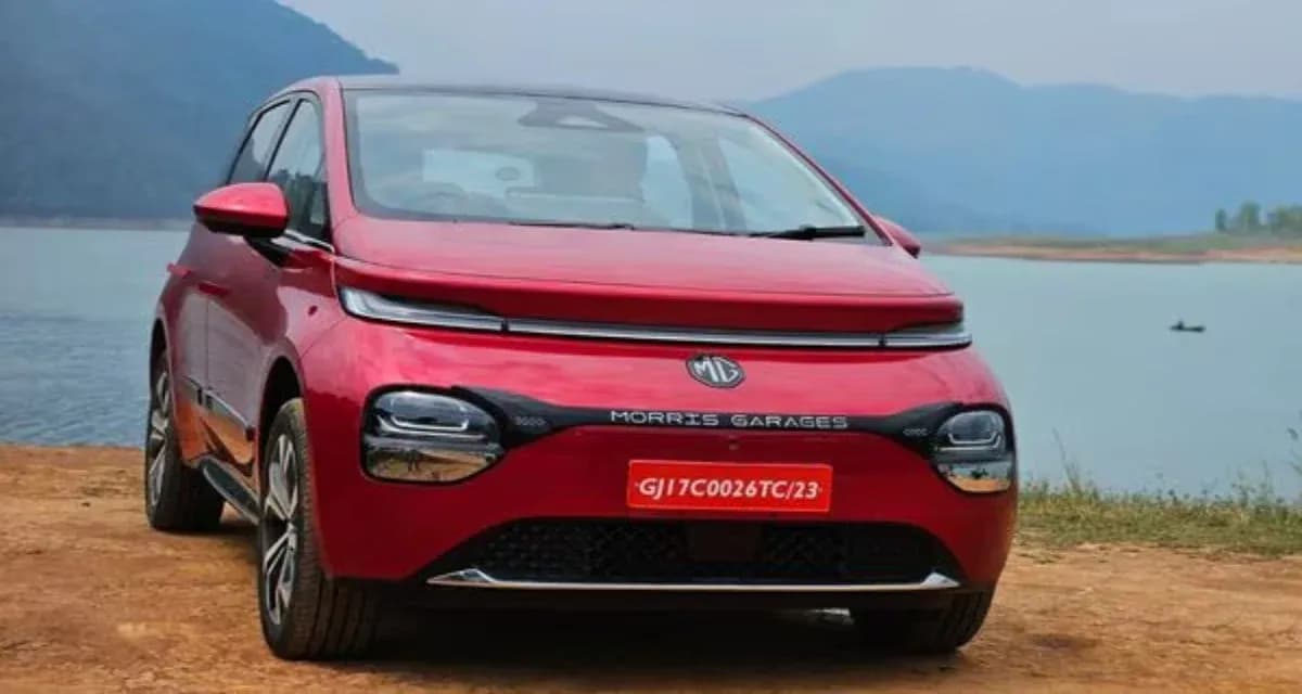 red mg windsor ev near a lake